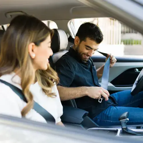 Couple buckling seat belts in a car