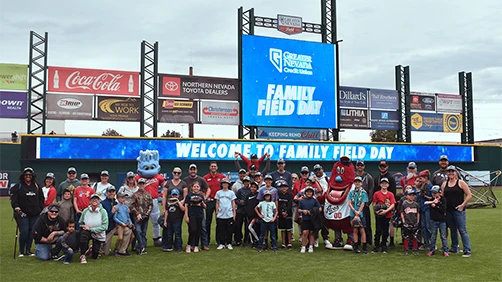 Group photo of Family Field Day participants at Greater Nevada Field