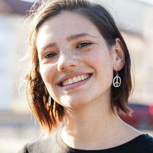 Young woman with peace earrings