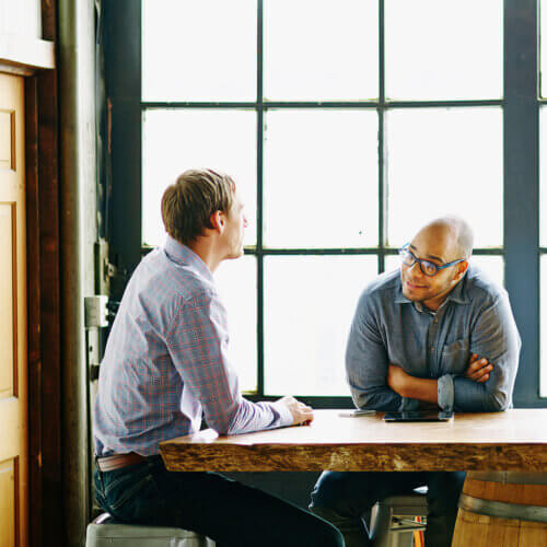 Two male business owners talking together