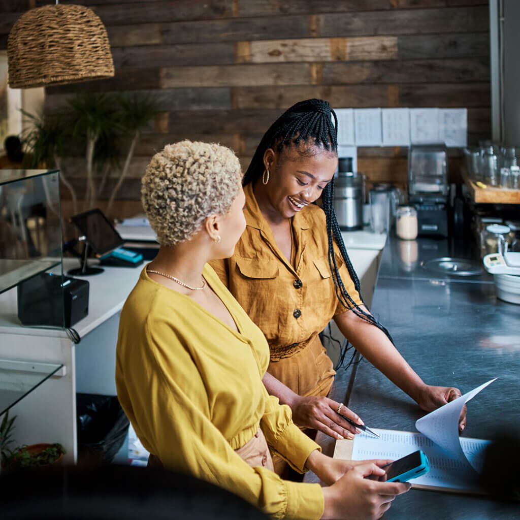 Two female business owners talking together