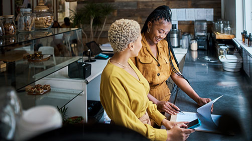 Two female business owners talking together