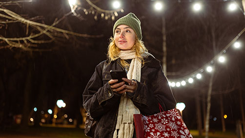 Woman looking at her phone after holiday shopping