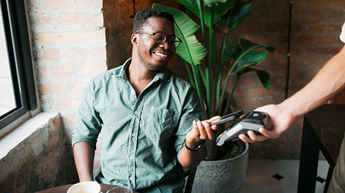 Man paying with a mobile wallet at a restaurant