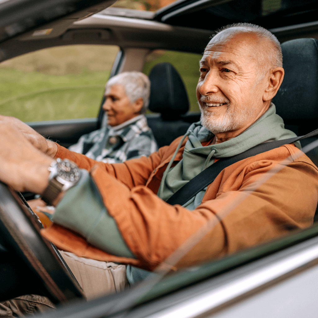 Older couple driving and feeling relieved after securing Mechanical Breakdown Protection (MBP)