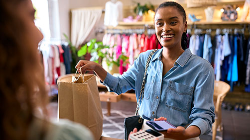 Woman doing mobile payment at a store